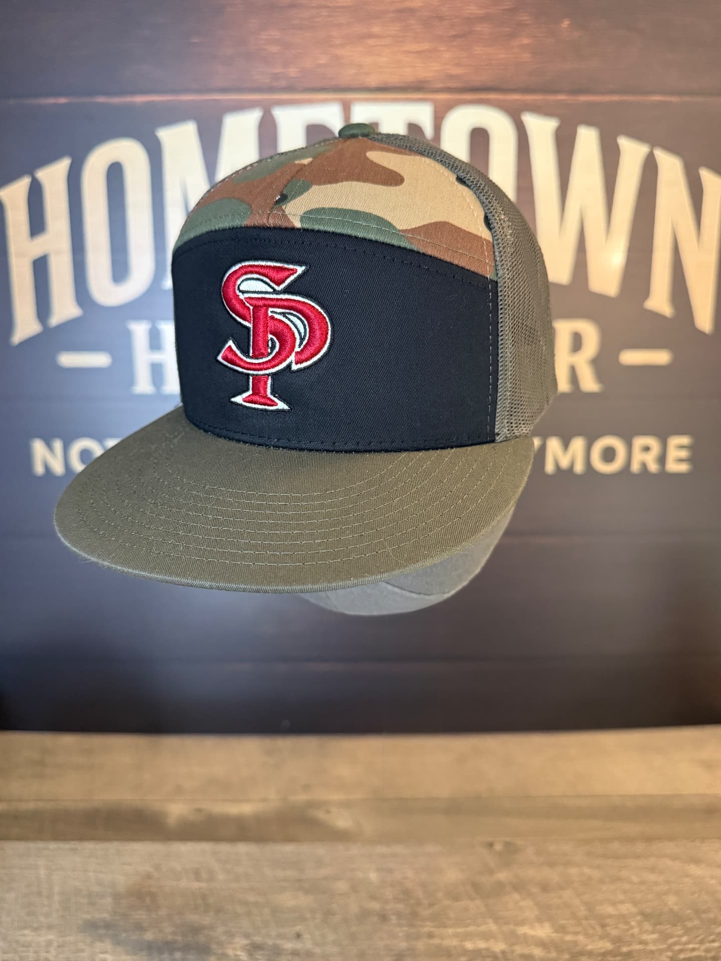 Camo and black trucker hat with red SP monogram embroidery